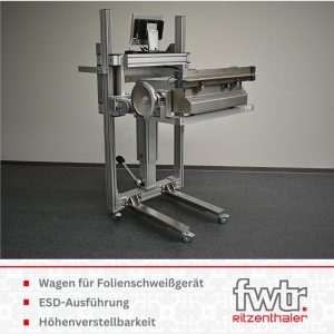 Wagon für ein Folienschweißgerät aus Aluprofilen mit ESD-fähigen Lenkrollen. Darunter steht Wagen für Folienschweißgerät, ESD-Ausführung und Höhenverstellbarkeit.